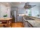 Well-equipped kitchen with granite countertops, stainless appliances, and a cooktop at 8374 Chisolm Plantation Rd, Edisto Island, SC 29438