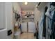 Functional laundry room featuring a washer, dryer, and storage shelves at 8374 Chisolm Plantation Rd, Edisto Island, SC 29438
