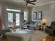 Open living room features hardwood floors, a ceiling fan, and a walk out balcony at 8374 Chisolm Plantation Rd, Edisto Island, SC 29438