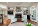 Open living room features hardwood floors, a fireplace, and a breakfast table at 8374 Chisolm Plantation Rd, Edisto Island, SC 29438