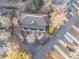 Aerial view of townhomes with mature trees, a driveway and parking lot showcasing available parking at 8409 Hidden Bakers Trce, North Charleston, SC 29418