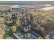 An aerial view showcases a community surrounded by lush trees next to a scenic body of water at 8409 Hidden Bakers Trce, North Charleston, SC 29418