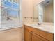 Bright bathroom features a sink vanity, large mirror, and window, offering comfort and functionality at 8409 Hidden Bakers Trce, North Charleston, SC 29418