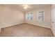 Bright bedroom featuring neutral walls, soft carpet, ceiling fan, and two windows providing lots of natural light at 8409 Hidden Bakers Trce, North Charleston, SC 29418