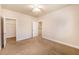 This bedroom has carpet, neutral walls, and a door leading to the closet and also stairs at 8409 Hidden Bakers Trce, North Charleston, SC 29418