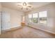 Well-lit bedroom with multiple windows overlooking backyard views, plus a ceiling fan and carpeted floors at 8409 Hidden Bakers Trce, North Charleston, SC 29418
