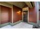 Private entrance to the townhouse featuring a covered porch, exterior light fixture, and a secure front door at 8409 Hidden Bakers Trce, North Charleston, SC 29418