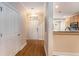 Inviting entryway with wood-look flooring, leading to an open kitchen with granite countertops at 8409 Hidden Bakers Trce, North Charleston, SC 29418