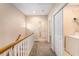 Hallway with natural light, leading to bedrooms, bathrooms, and a utility closet with a washer at 8409 Hidden Bakers Trce, North Charleston, SC 29418