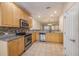 Well-lit kitchen showcasing stainless steel appliances and granite countertops, flowing into a dining area at 8409 Hidden Bakers Trce, North Charleston, SC 29418