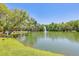Scenic lake view featuring a fountain and lush green trees at 8409 Hidden Bakers Trce, North Charleston, SC 29418