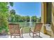 Beautiful lake view with fountain from porch with two rocking chairs at 8409 Hidden Bakers Trce, North Charleston, SC 29418