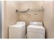 Functional laundry room equipped with modern appliances and convenient overhead shelving for efficient organization at 8409 Hidden Bakers Trce, North Charleston, SC 29418