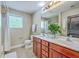 Bathroom with double vanity, cherry wood cabinets, neutral walls, tile floor and combination tub/shower at 9707 Seed St, Ladson, SC 29456