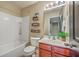 Bathroom with cherry wood cabinets, neutral walls, tile floor and combination tub/shower at 9707 Seed St, Ladson, SC 29456