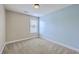 Bedroom with neutral walls, carpet, and a window with blinds for natural light at 9707 Seed St, Ladson, SC 29456