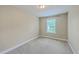Bedroom with neutral walls, carpet, and a window with blinds for natural light at 9707 Seed St, Ladson, SC 29456