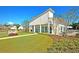 The Club at McKewn offers a modern white clubhouse with manicured lawn and verdant landscaping at 9707 Seed St, Ladson, SC 29456