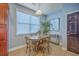 Bright dining nook area featuring natural light, a round table, and views of the home's front entrance at 9707 Seed St, Ladson, SC 29456