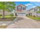 Inviting two-story home with a spacious driveway, lush lawn, and classic white siding at 9707 Seed St, Ladson, SC 29456