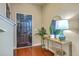 Inviting entryway with wood floors, a black front door, a mirrored wall, and stylish decor at 9707 Seed St, Ladson, SC 29456