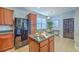 Kitchen featuring a center island, stainless steel refrigerator, dining area, and backyard access at 9707 Seed St, Ladson, SC 29456