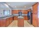 Spacious kitchen featuring wood cabinetry, an island, modern appliances, and backyard access at 9707 Seed St, Ladson, SC 29456