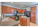 Functional kitchen featuring a center island, abundant wood cabinets, and stainless steel appliances at 9707 Seed St, Ladson, SC 29456