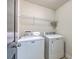 Bright laundry room with white washer and dryer and wire shelving for organized storage at 9707 Seed St, Ladson, SC 29456
