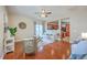 Bright and open living room with hardwood floors, contemporary furnishings, and a view into the kitchen at 9707 Seed St, Ladson, SC 29456
