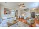 Open concept living room with hardwood floors, ceiling fan, and a comfortable seating arrangement at 9707 Seed St, Ladson, SC 29456