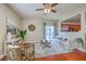 Well-lit living room featuring hardwood floors, contemporary furnishings, a ceiling fan, and sliding glass doors at 9707 Seed St, Ladson, SC 29456