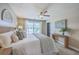 Bright main bedroom featuring neutral walls, a ceiling fan, a woven headboard, and stylish decor at 9707 Seed St, Ladson, SC 29456