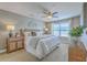 Bright main bedroom featuring a ceiling fan, window, and stylish decor on the bedside tables at 9707 Seed St, Ladson, SC 29456