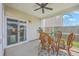 Inviting screened porch with wicker seating, ceiling fan, and sliding door access to the house at 9707 Seed St, Ladson, SC 29456