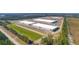 Aerial view of industrial warehouses surrounded by ponds, trees, and roadway at 100 Fish Rd, Ridgeville, SC 29472