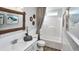 Bathroom with modern wallpaper, decorative wood framed mirror, granite vanity, and tiled shower-tub combination at 100 Fish Rd, Ridgeville, SC 29472
