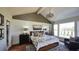 Cozy bedroom with a vaulted ceiling, a large window with backyard views, and elegant decor at 100 Fish Rd, Ridgeville, SC 29472