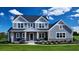 Charming two-story home featuring board and batten siding, large front porch, and manicured landscaping at 100 Fish Rd, Ridgeville, SC 29472