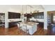 Stylish kitchen featuring dark wood cabinets, granite countertops, brick-faced island, and stainless steel appliances at 100 Fish Rd, Ridgeville, SC 29472