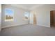 Bright, airy bedroom featuring neutral tones, plush carpeting, and abundant natural light from two large windows at 100 Hawthorne Landing Dr, Goose Creek, SC 29445