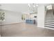 Open concept living area with hardwood floors, white walls, and a kitchen island, perfect for entertaining at 100 Hawthorne Landing Dr, Goose Creek, SC 29445