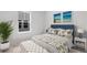 Well-lit bedroom with a large window, stylish decor, and comfortable furnishings at 1023 Swamp Rose Run, Summerville, SC 29485