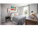 Modern bedroom featuring unique skateboard wall decor, neutral colors, and natural light from the window at 1023 Swamp Rose Run, Summerville, SC 29485