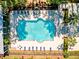A high-angle shot shows off a sparkling pool with lounge chairs and tables and some leafy plants at 1025 Riverland Woods Pl # 106, Charleston, SC 29412