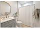 Charming bathroom with gray cabinets, decorative mirror, and shower with curtain at 1025 Riverland Woods Pl # 106, Charleston, SC 29412