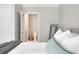 View of the bedroom and adjoining half-bathroom featuring neutral colors and modern fixtures at 1025 Riverland Woods Pl # 106, Charleston, SC 29412