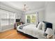 Bright bedroom featuring hardwood floors, a ceiling fan, and large windows at 1025 Riverland Woods Pl # 106, Charleston, SC 29412