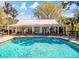 A view of a well-maintained clubhouse and inviting community pool, perfect for relaxation at 1025 Riverland Woods Pl # 106, Charleston, SC 29412