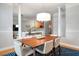 Dining area with pillars, modern chandelier, and a view into the living room and kitchen at 1025 Riverland Woods Pl # 106, Charleston, SC 29412